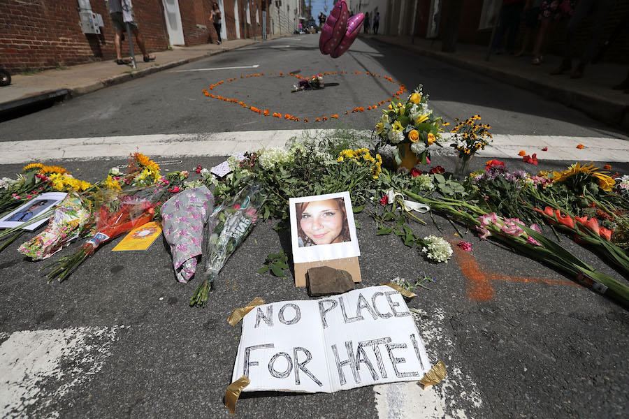 CHARLOTTESVILLE, VA - AUGUST 13: Flowers surround a photo of 32-year-old Heather Heyer, who was killed when a car plowed into a crowd of people protesting against the white supremacist Unite the Right rally, August 13, 2017 in Charlottesville, Virginia. Charlottesville is calm the day after violence errupted around the Unite the Right rally, a gathering of white nationalists, neo-Nazis, the Ku Klux Klan and members of the 'alt-right,' that left Heyer dead and injured 19 others. (Photo by Chip Somodevilla/Getty Images)