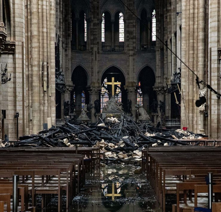 Fire damaged wood and stone sits near the altar inside Notre Dame Cathedral in Paris, France, on Tuesday, April 16, 2019. Authorities declared Tuesday morning that the blaze had been contained as firefighters hosed the south side of the transept to cool down the building, and a district around the cathedral was sealed as military and police patrolled the area. Photographer: Christophe Morin/Bloomberg