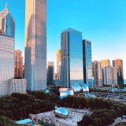 Photo image of the downtown landscape of chicago featuring tall buildings and the famous chicago cloud gate aka the bean in Millennium Park